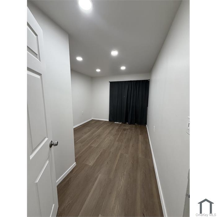 803 Jackson Avenue, Unit A Bronx, NY 10456 - Photo 6 of 8 a view of an empty room with wooden floor