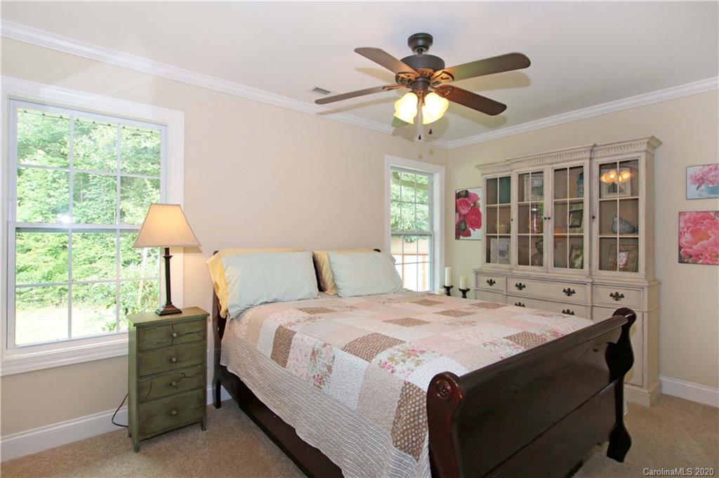 200 McCrary Road Mooresville, NC 28117 - Photo 15 of 41 a bedroom with a bed and a chandelier