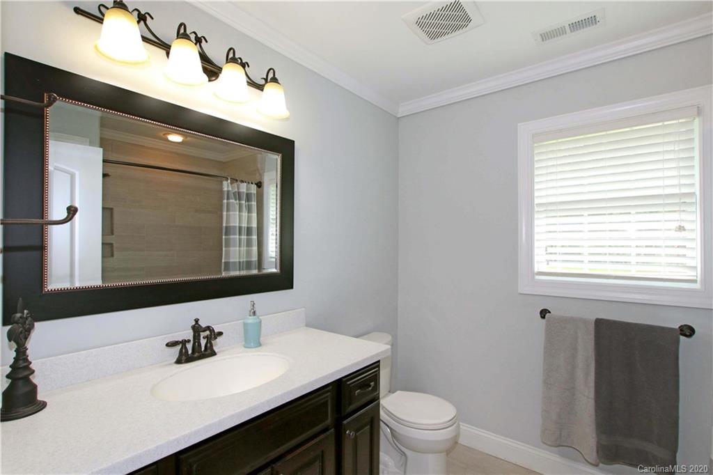 200 McCrary Road Mooresville, NC 28117 - Photo 16 of 41 a bathroom with a toilet sink and mirror