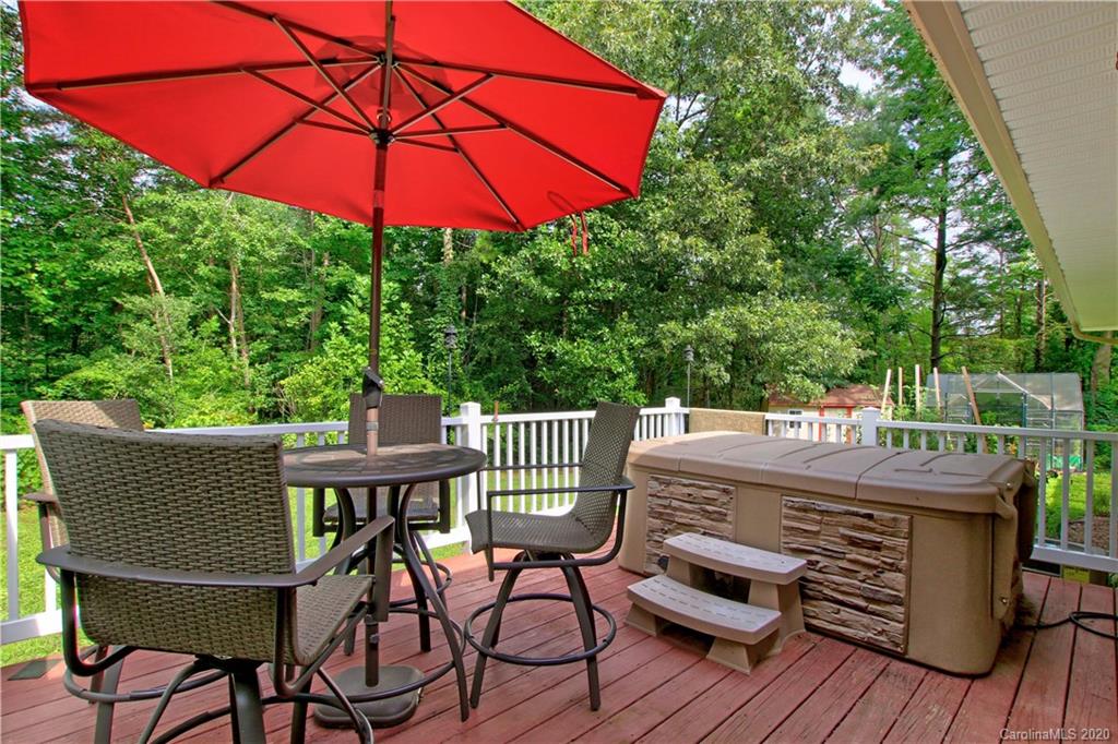 200 McCrary Road Mooresville, NC 28117 - Photo 19 of 41 a view of a roof deck with table and chairs under an umbrella