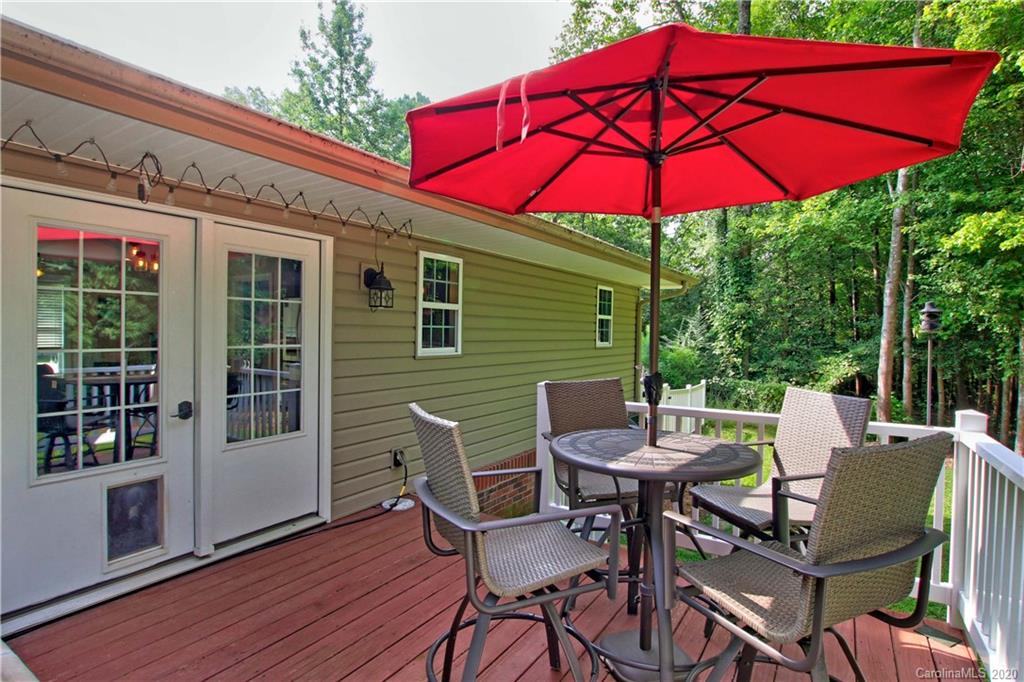 200 McCrary Road Mooresville, NC 28117 - Photo 20 of 41 a view of a patio with a table and chairs under an umbrella