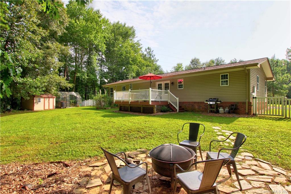 200 McCrary Road Mooresville, NC 28117 - Photo 22 of 41 a view of a patio with table and chairs potted plants and large tree