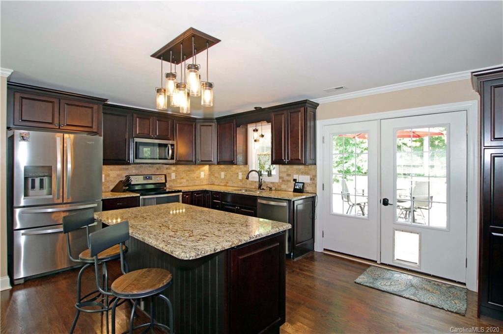 200 McCrary Road Mooresville, NC 28117 - Photo 6 of 41 a kitchen with granite countertop a sink stove and refrigerator
