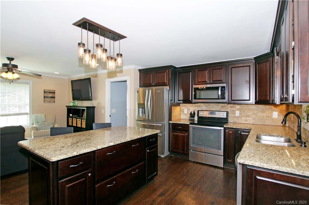 200 McCrary Road Mooresville, NC 28117 - Photo 7 of 41 a kitchen with a kitchen island hardwood floor and a sink