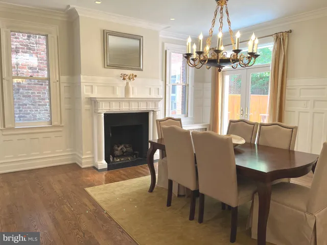 a view of a dining room with furniture and a chandelier