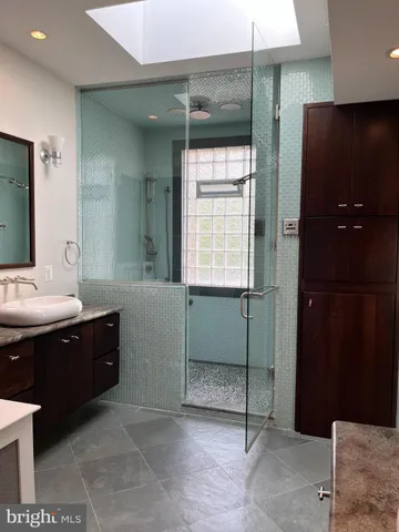 a bathroom with a sink and mirror