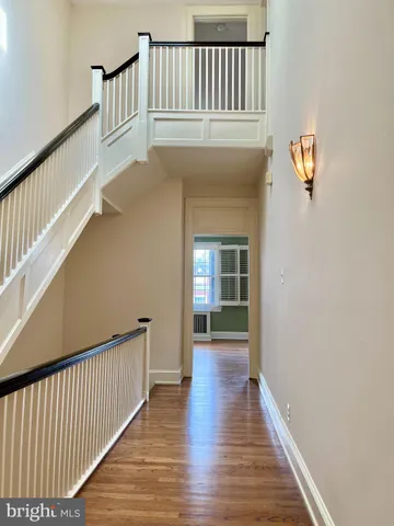 a view of entryway and hall with wooden floor