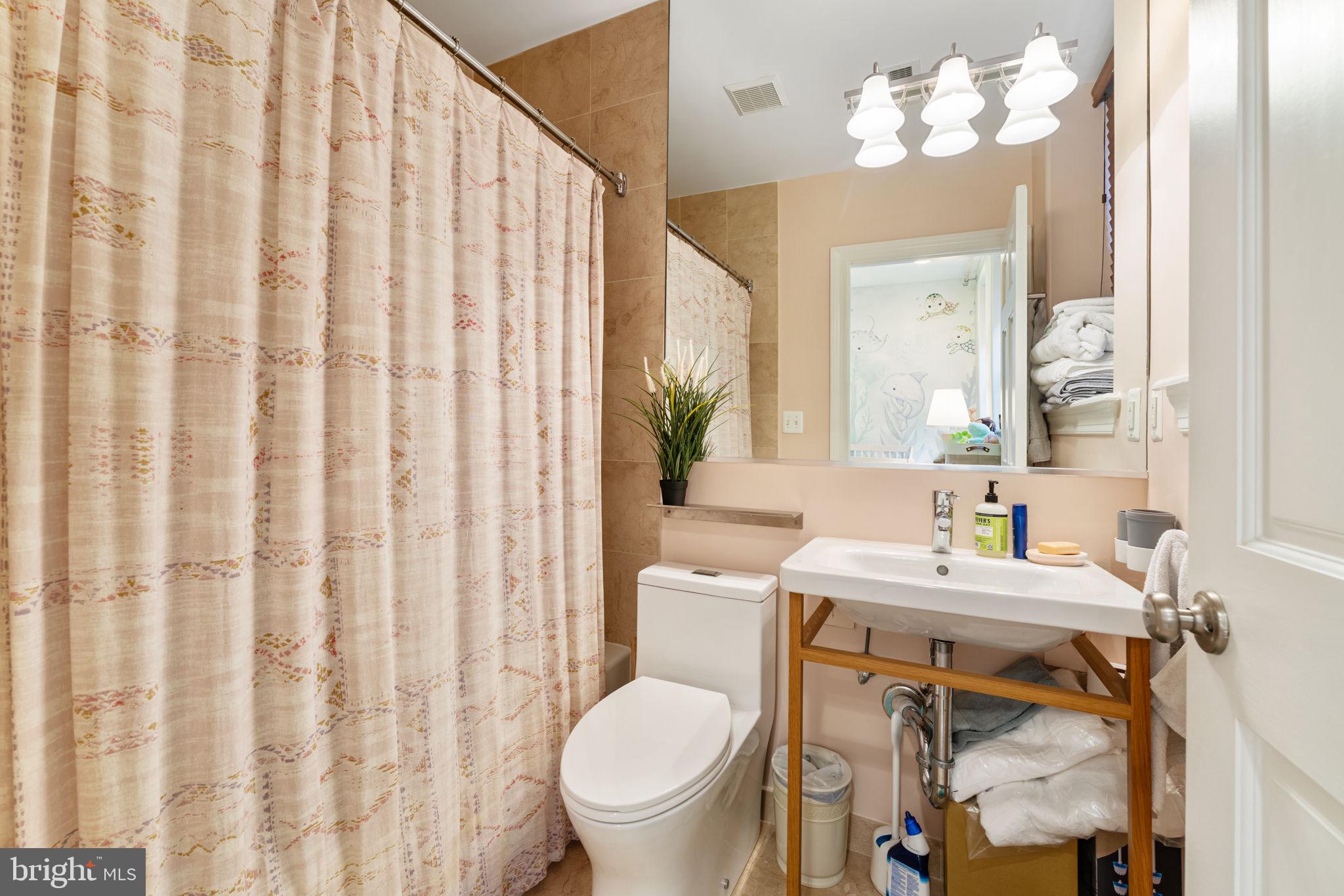 1105 Park Road Northwest, Unit 3 Washington, DC 20010 - Photo 14 of 20 a bathroom with a sink a toilet and a mirror