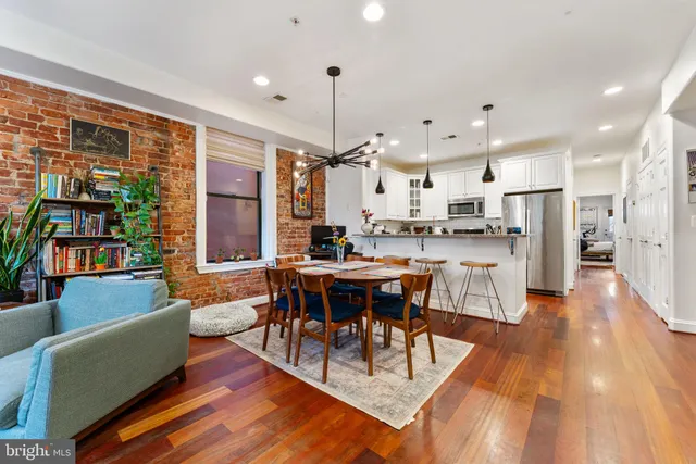 a dining room filled with furniture and wooden floor