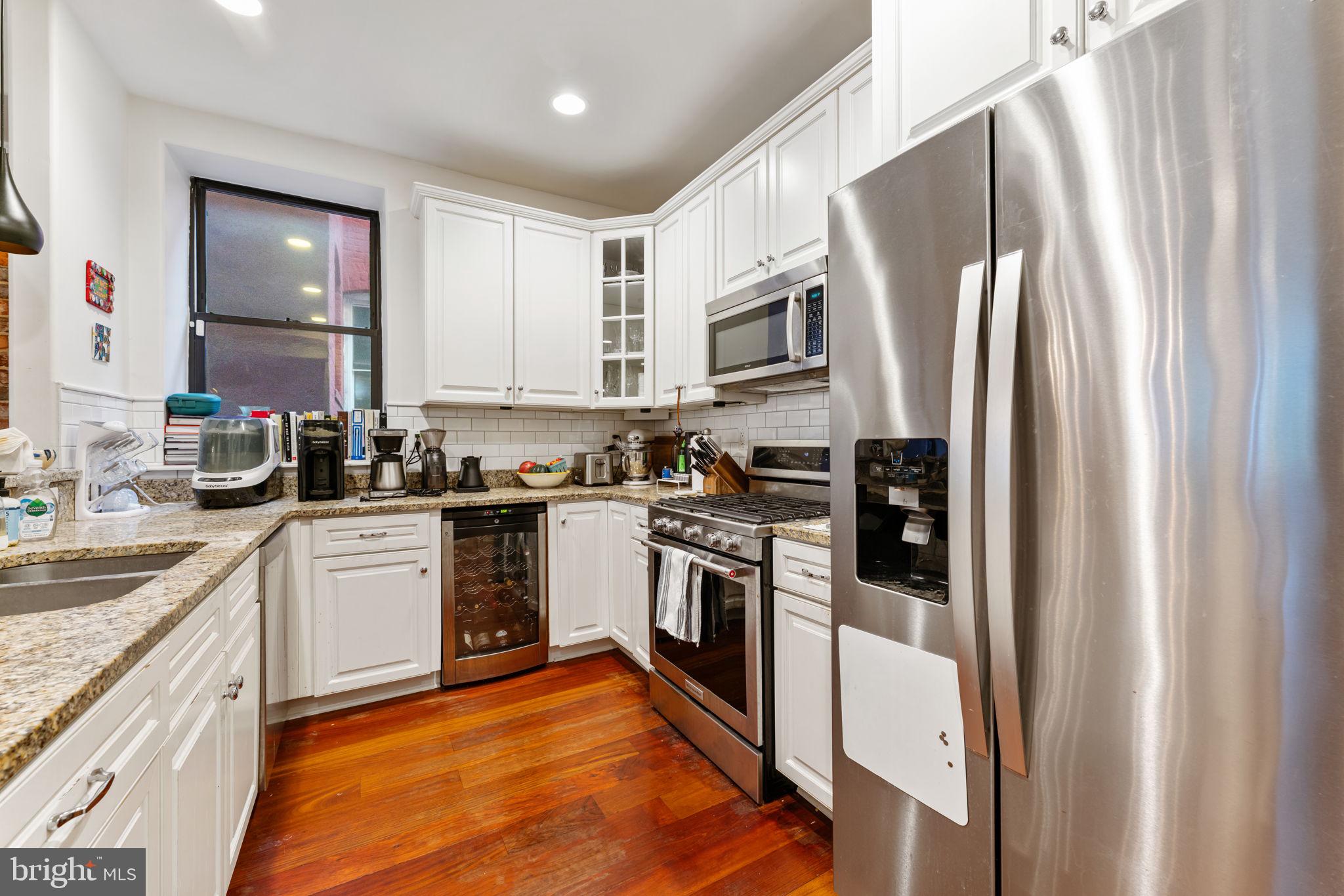 1105 Park Road Northwest, Unit 3 Washington, DC 20010 - Photo 9 of 20 a kitchen with stainless steel appliances a refrigerator sink and microwave