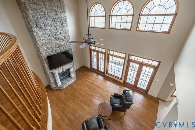 a living room with furniture a fireplace and a floor to ceiling window