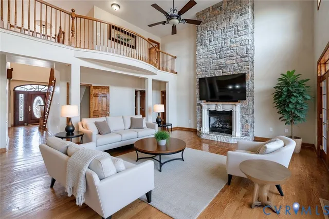 a living room with furniture a fireplace and a potted plant