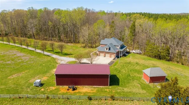 an aerial view of a house with a swimming pool