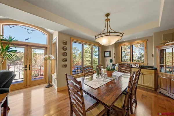 a view of a dining room with furniture window and wooden floor