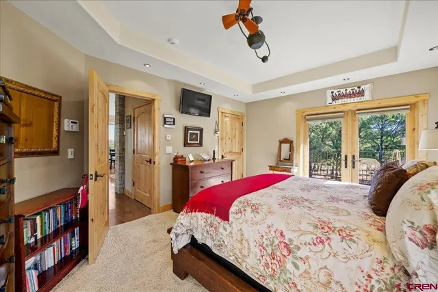 a bedroom with a bed and a chandelier