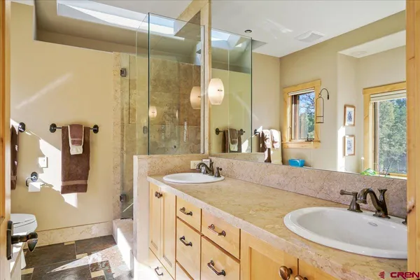 a bathroom with a sink double vanity and a mirror
