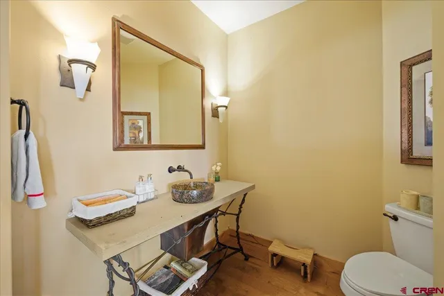 a bathroom with a sink vanity mirror and toilet