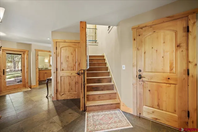 a view of a hallway with wooden floor and entryway