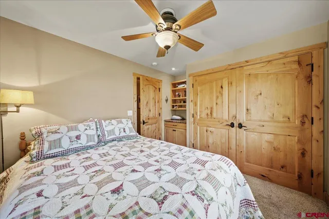 a bedroom with a large bed and a chandelier