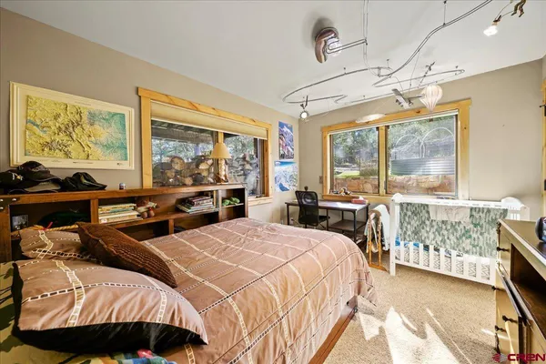 a bedroom with a bed and large window