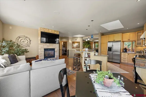 a living room with furniture a fireplace and a flat screen tv