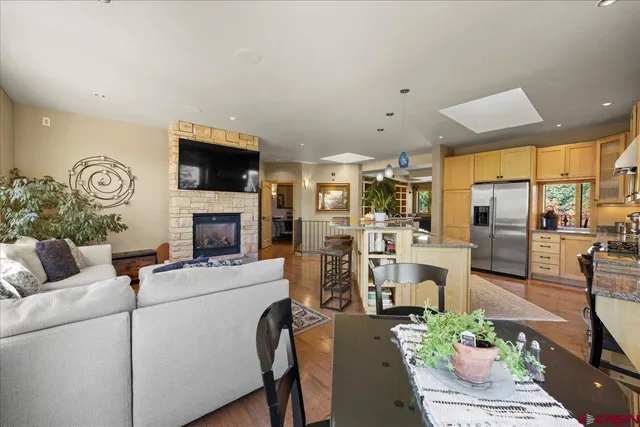 a living room with furniture a fireplace and a flat screen tv