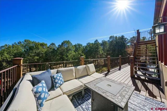 a view of a roof deck with couches and wooden floor