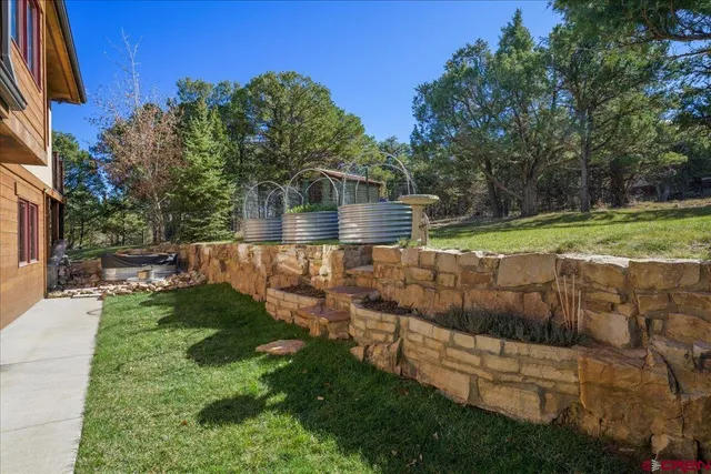 a view of a backyard with wooden fence