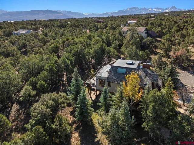 an aerial view of a house with a yard