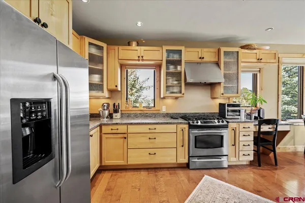 a kitchen with stainless steel appliances granite countertop a stove and a refrigerator