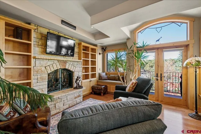 a living room with furniture a fireplace and a flat screen tv