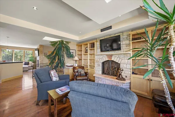 a living room with furniture a flat screen tv and a fireplace