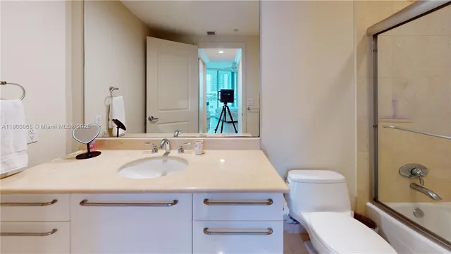 a bathroom with a sink toilet and mirror