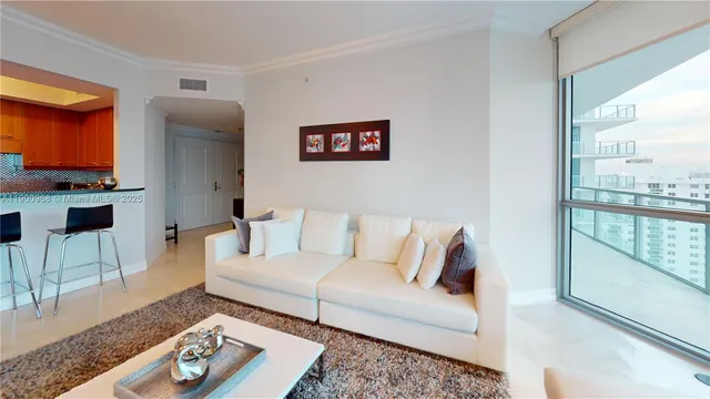 a living room with furniture and a floor to ceiling window