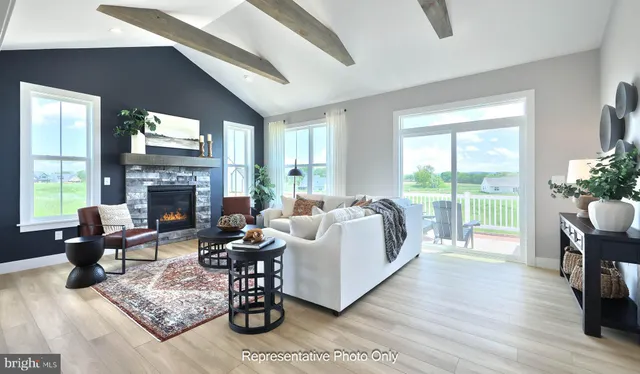 a living room with fireplace furniture and a large window