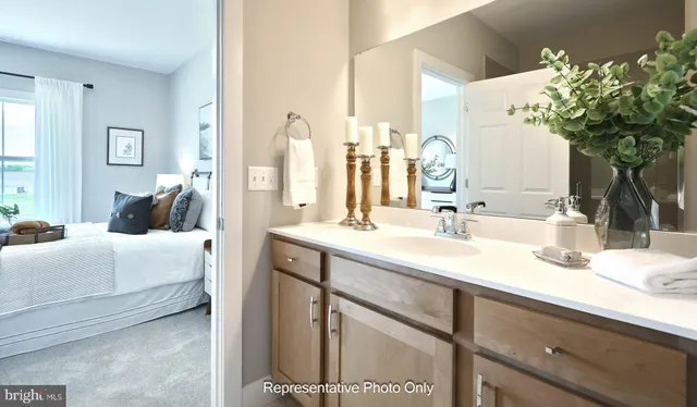 a bedroom with a large bed and a mirror