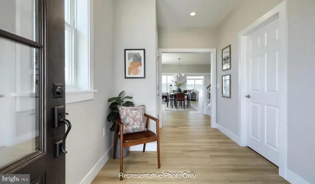 a hallway with wooden floor and furniture