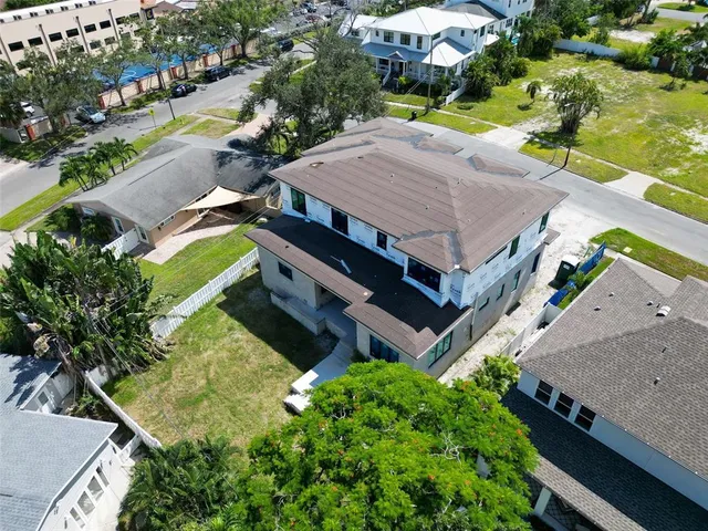 an aerial view of a house with a yard basket ball court and outdoor seating
