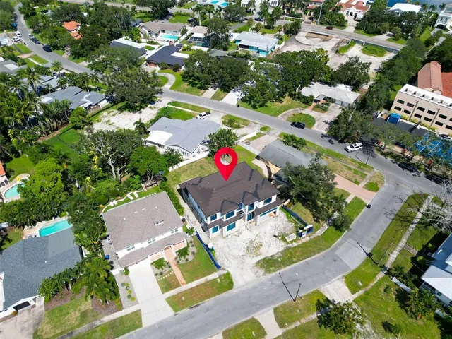 an aerial view of residential house with outdoor space and swimming pool