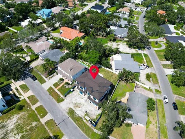 an aerial view of a house with a yard and pool
