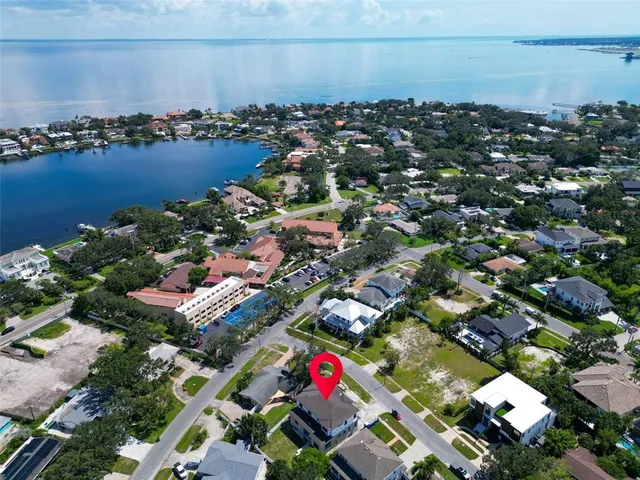 an aerial view of residential houses with outdoor space and swimming pool