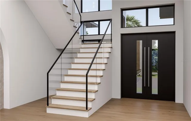 a view of entryway with wooden floor and stairs