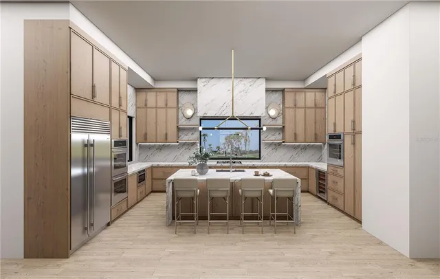 a kitchen with stainless steel appliances granite countertop a refrigerator a oven a sink with island and chairs