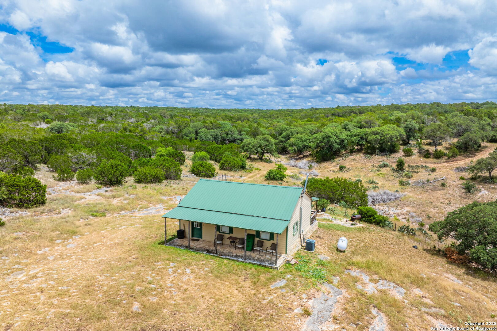 485 Mitchell Ranch Road Camp Wood, TX 78833 - Photo 27 of 47 a view of a yard with plants and a bench