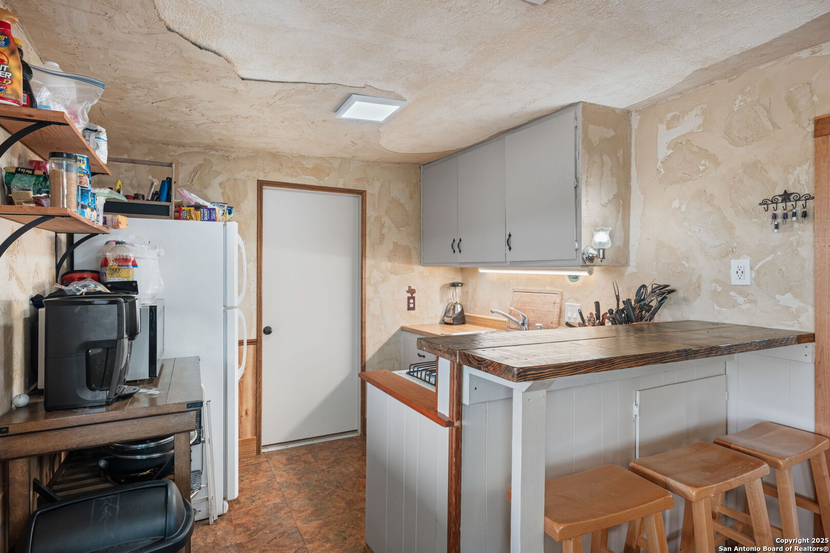 485 Mitchell Ranch Road Camp Wood, TX 78833 - Photo 30 of 47 a kitchen with a sink stove and cabinets