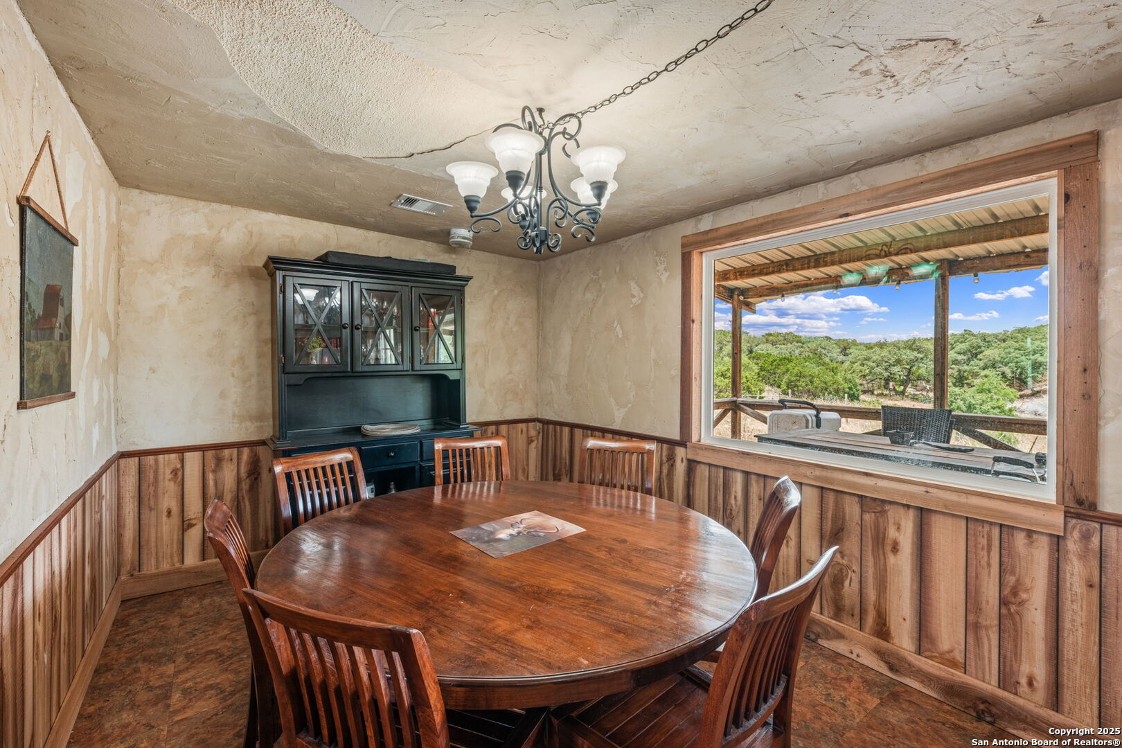 485 Mitchell Ranch Road Camp Wood, TX 78833 - Photo 34 of 47 a view of a dining room with furniture a chandelier and wooden floor