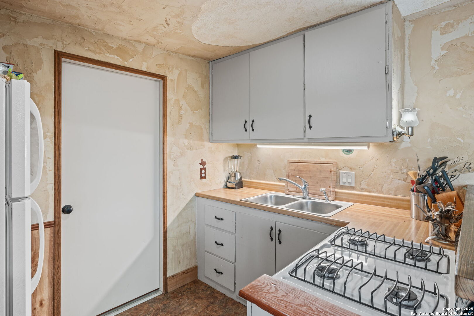 485 Mitchell Ranch Road Camp Wood, TX 78833 - Photo 35 of 47 a kitchen with a sink and cabinets