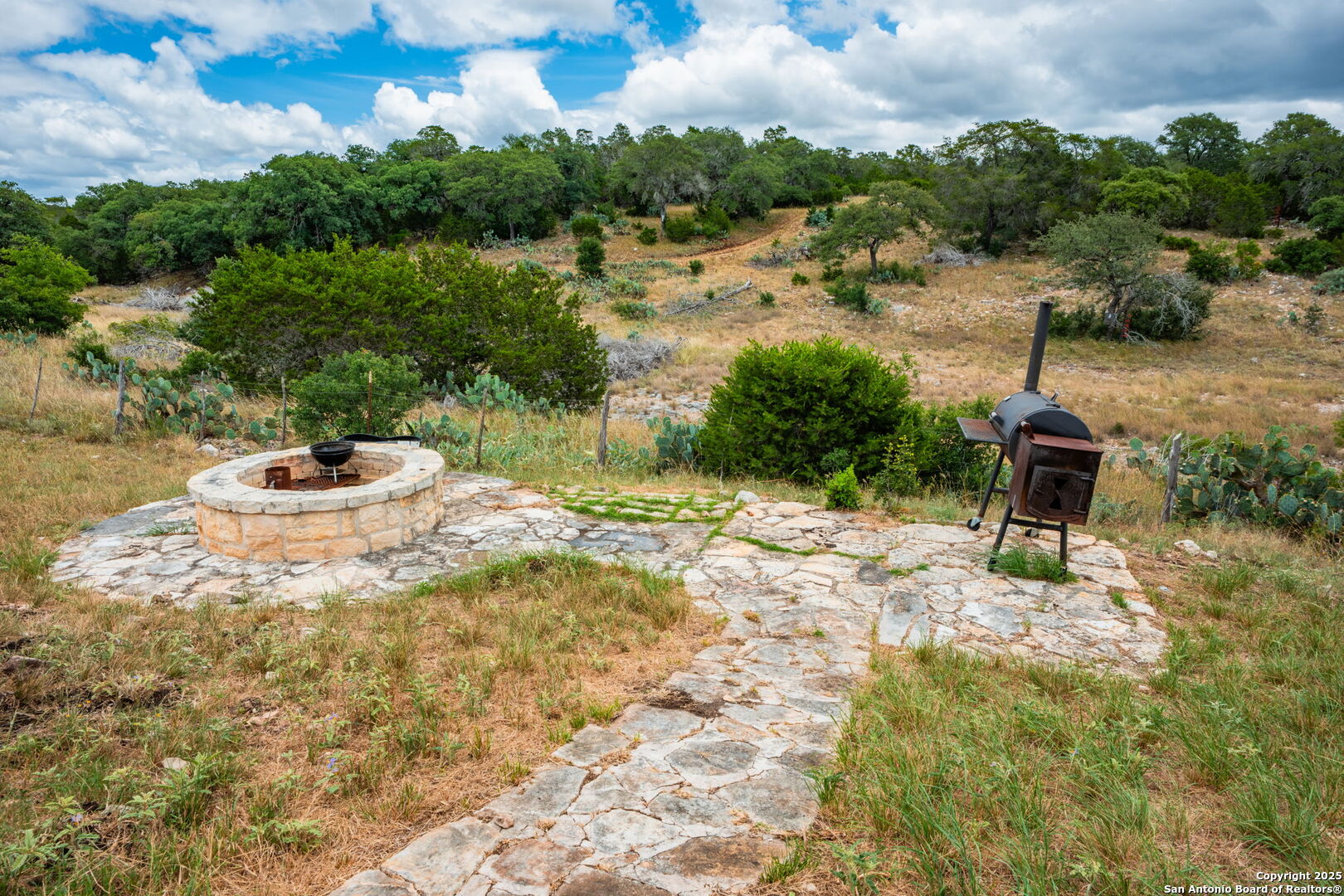 485 Mitchell Ranch Road Camp Wood, TX 78833 - Photo 39 of 47 a backyard of a house with table and chairs