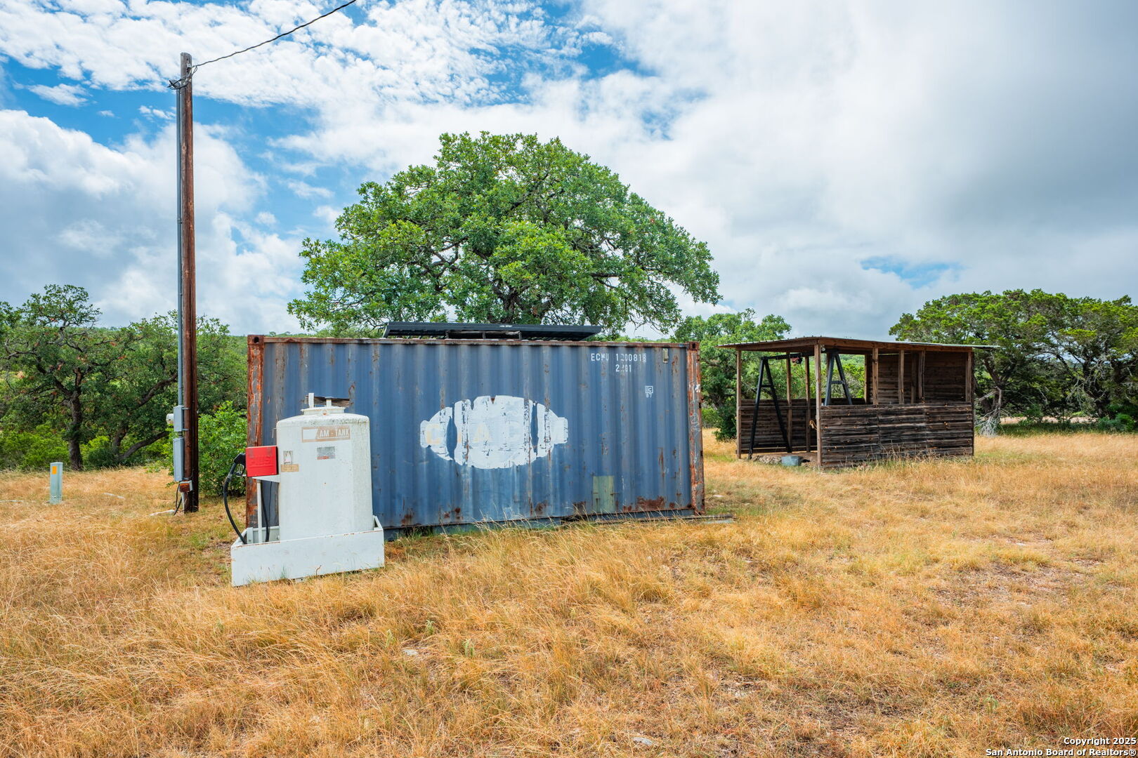 485 Mitchell Ranch Road Camp Wood, TX 78833 - Photo 42 of 47 a view of a backyard with a tree and wooden fence