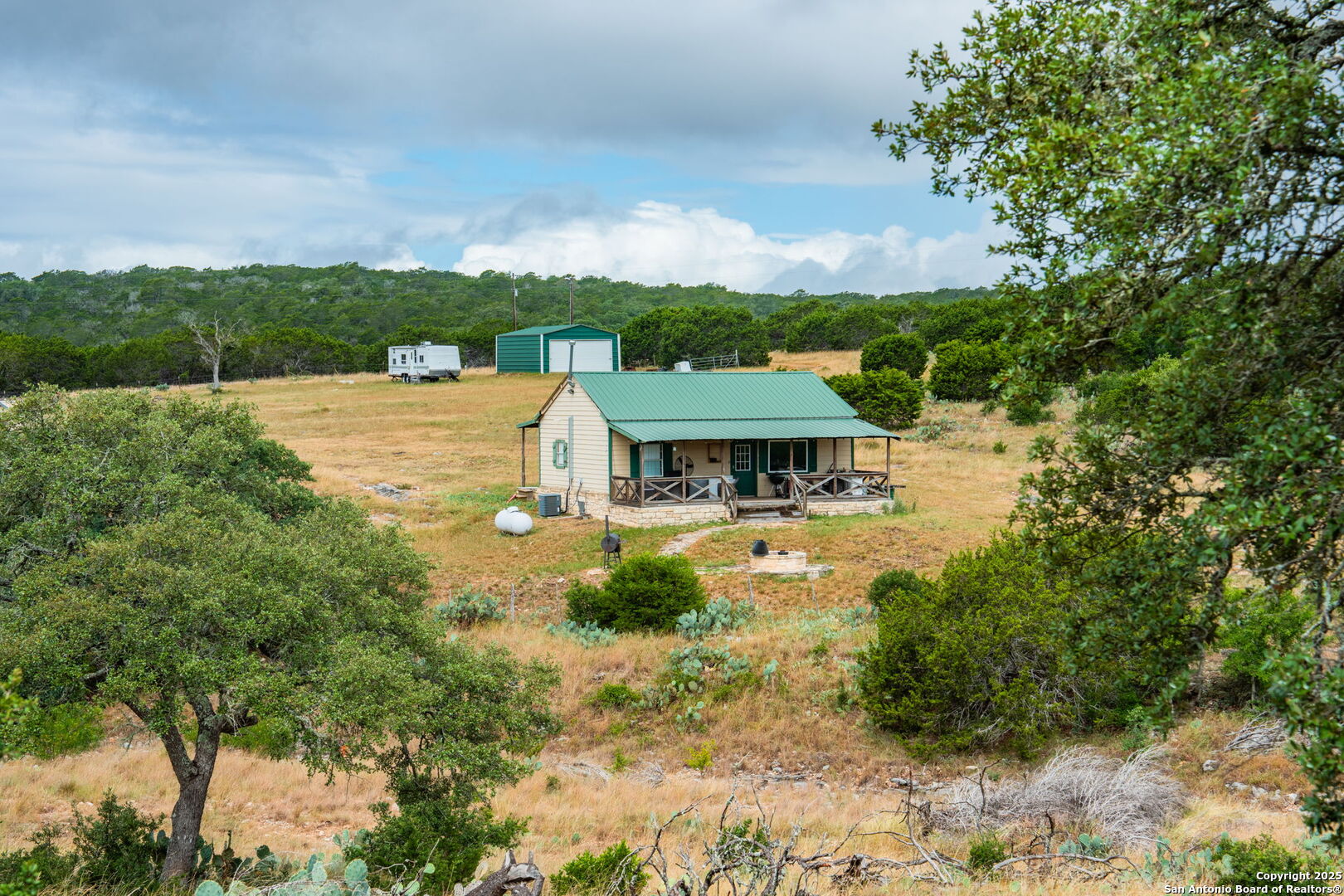485 Mitchell Ranch Road Camp Wood, TX 78833 - Photo 44 of 47 a view of a garden with a house in the background